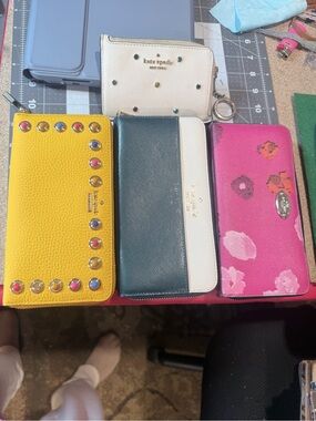 Kate Spade bundle. Three wallets all New and one card holder. Excellent buy